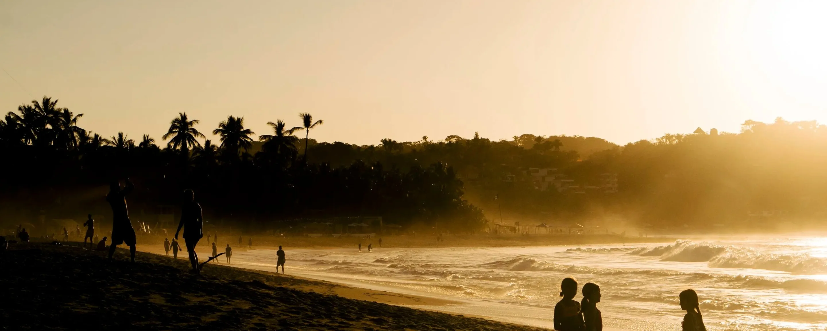 Golden hour on the beach in Sayulita, Nayarit, with surf rolling in at sunset